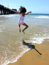 Full length of man jumping on beach