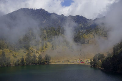 Scenic view of kumbolo lake, indonesia, on foggy morning