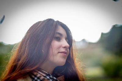 Portrait of a beautiful young woman looking away