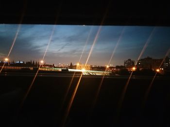 Illuminated city against sky at night