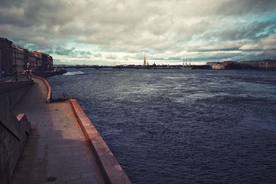 Bridge over sea against sky in city