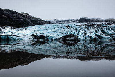 Scenic view of iceland glacier against sky and mountain during winter with reflections