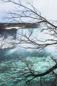 Scenic view of frozen lake against sky during winter