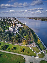 High angle view of buildings by sea against sky