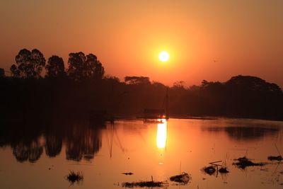 Scenic view of lake against sky during sunset