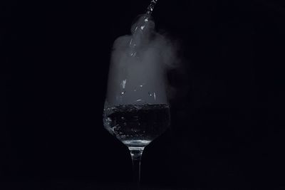 Close-up of wine bottles against black background