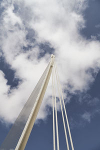 Low angle view of crane against sky