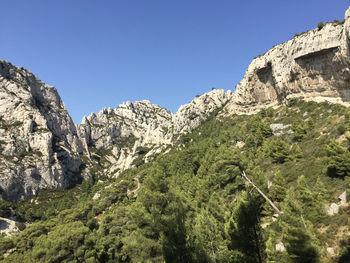 Low angle view of mountain against clear blue sky