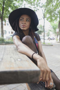 A young woman wearing a black hat.