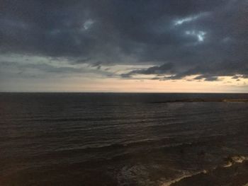 Scenic view of sea against storm clouds