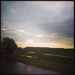 Scenic view of landscape against cloudy sky