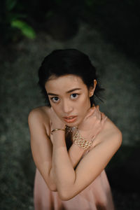 Portrait of young woman standing on field