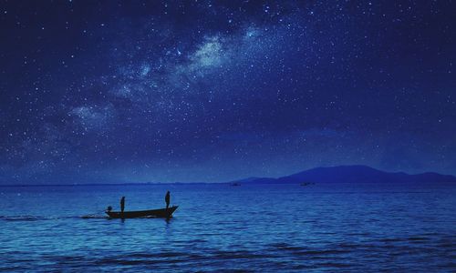 Side view of man in boat at calm sea