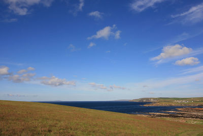 Scenic view of sea against blue sky