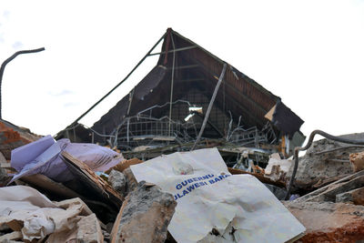 Low angle view of abandoned building against sky