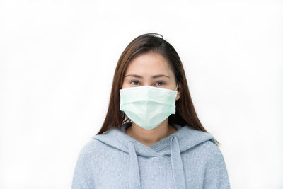 Portrait of a serious young woman over white background
