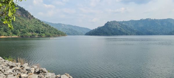 Scenic view of lake and mountains against sky