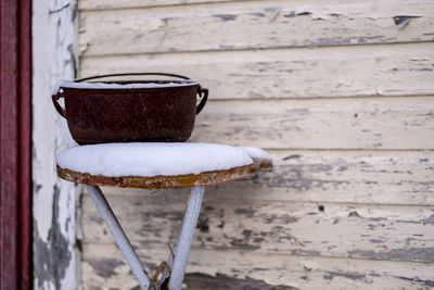 Close-up of iron pot on small wood table