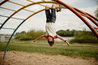 Portrait of young child hang on playground