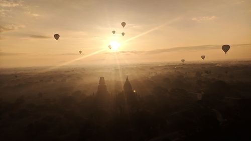 Silhouette of hot air balloon against sky during sunset