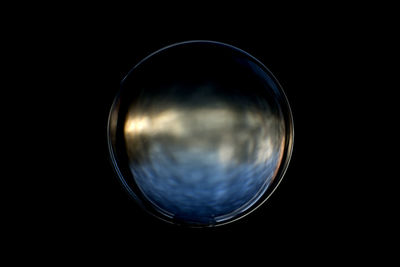 Close-up of bubbles against black background