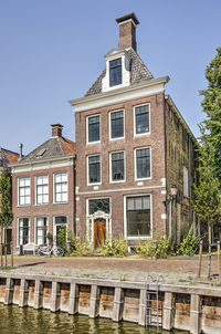 Traditional brick houses next to a dutch canal