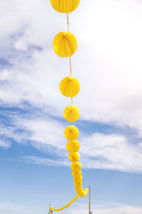 Low angle view of balloons against sky