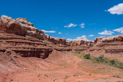 Low angle landscape of massive red boulders forming a wall in bluff, utah