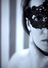 Close-up portrait of woman wearing eye mask at home