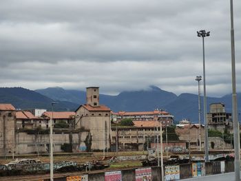 Buildings in town against sky