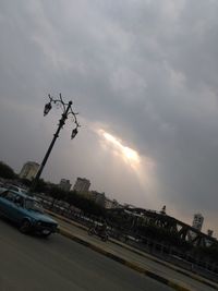 Cars on road against sky during sunset