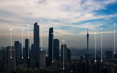 Modern buildings in city against sky during sunset