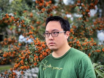 Portrait of young man against plants