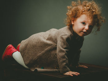 Portrait of cute boy sitting at home