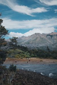 Scenic view of lake and mountains against sky