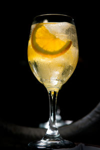 Close-up of beer glass on table against black background