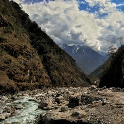 Scenic view of mountains against cloudy sky