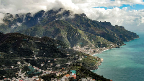 Scenic view of sea and mountains against sky