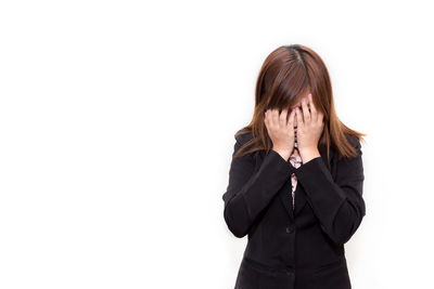 Low section of woman against white background