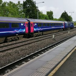 Train at railroad station against sky