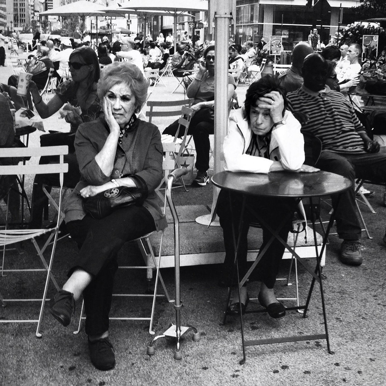 sitting, lifestyles, casual clothing, leisure activity, chair, full length, childhood, men, person, cafe, table, restaurant, incidental people, boys, large group of people, relaxation, city, day, street