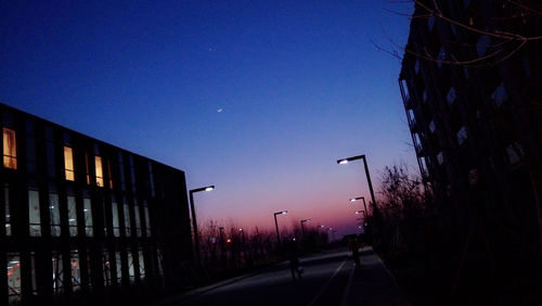 Road along buildings at dusk