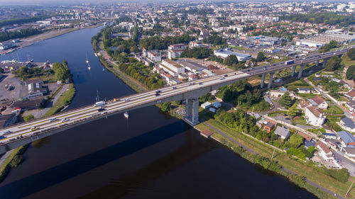 High angle view of bridge over river amidst buildings in city