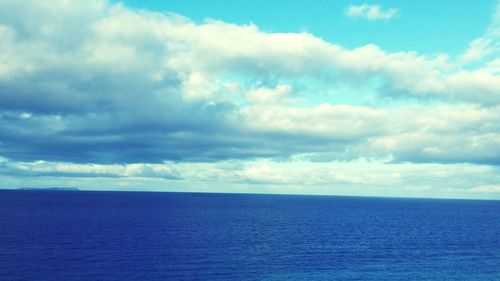 Scenic view of sea against cloudy sky