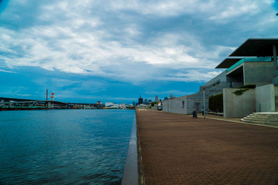 View of city by sea against sky