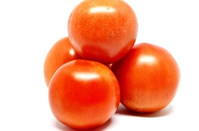 Close-up of tomatoes against white background