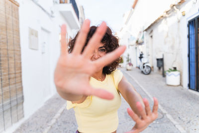 Midsection of woman standing by wall