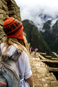 Rear view of woman looking at mountain during winter