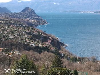 Scenic view of sea by mountains against sky