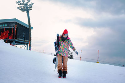 Rear view of person on snow covered landscape